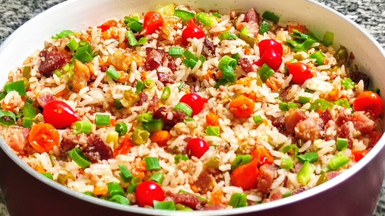 Arroz temperado de Natal com bacon, calabresa, vagem, cenoura, pimenta biquinho e cebolinha em uma panela
